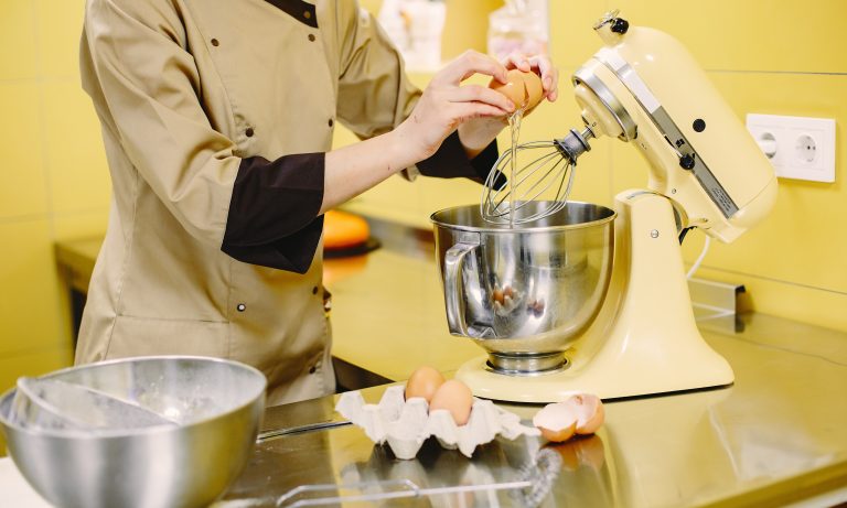 Female confectioner working with mixer